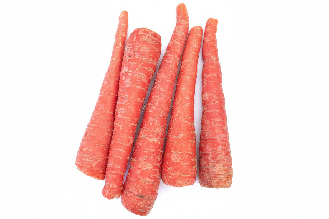 Five red-skinned carrots on a brown paper background
