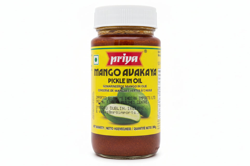 Jar of Yarinya Mango Avakaya Pickle in Oil on a white surface with a blurred background