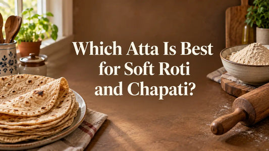 Soft homemade whole wheat rotis beside a bowl of atta and a wooden rolling pin.