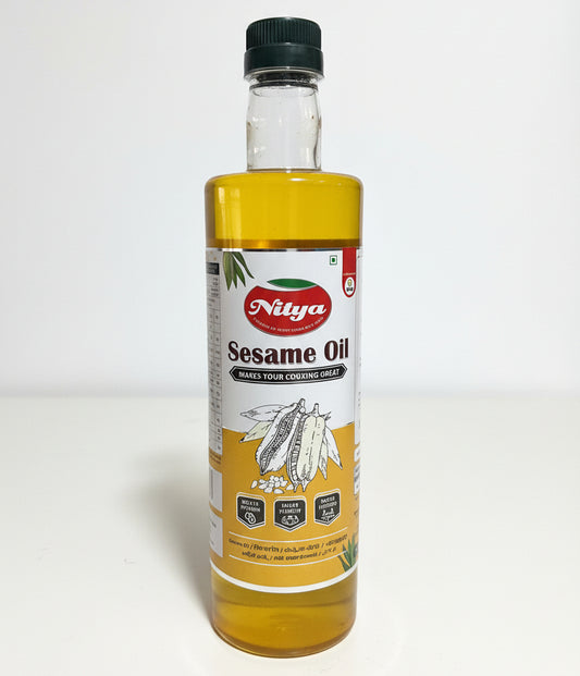Bottle of sesame oil with a yellow label on a white surface