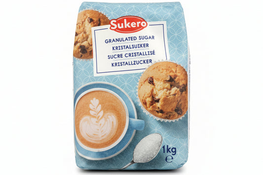 Sukero sugar package with a cup of coffee and cookies on a dark background